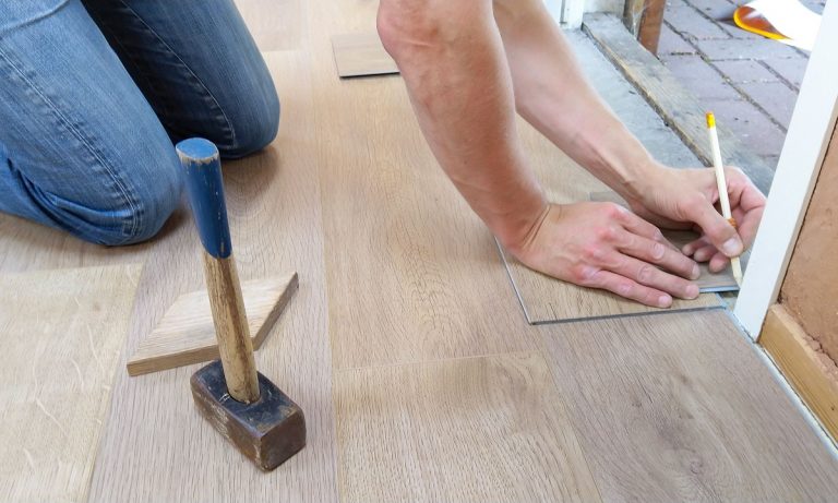 man installing vinyl flooring